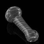 Transparent glass pipe with white stripes on a black background.