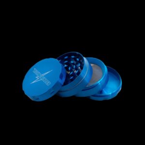 Blue plastic grinder with cross design on lid, used for grinding herbs.
