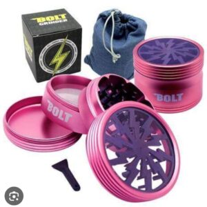 Pink four-piece herb grinder with a storage pouch and cleaning brush.