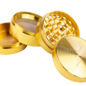 A shiny gold-colored metal grinder with multiple sections for grinding.