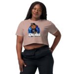 Woman wearing a beige crop top with a colorful lion graphic and black pants.