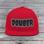 Red snapback hat with the word 'DOUBER' embroidered.